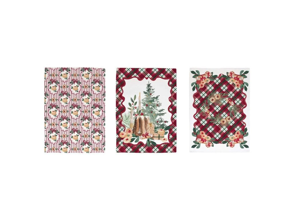 Tre canovacci natalizi Blanc Mariclo stesi: il primo a righe con pasticcini, il secondo con pandoro e candele su fondo bianco, il terzo con ghirlanda e biscotti su fondo tartan rosso e verde.