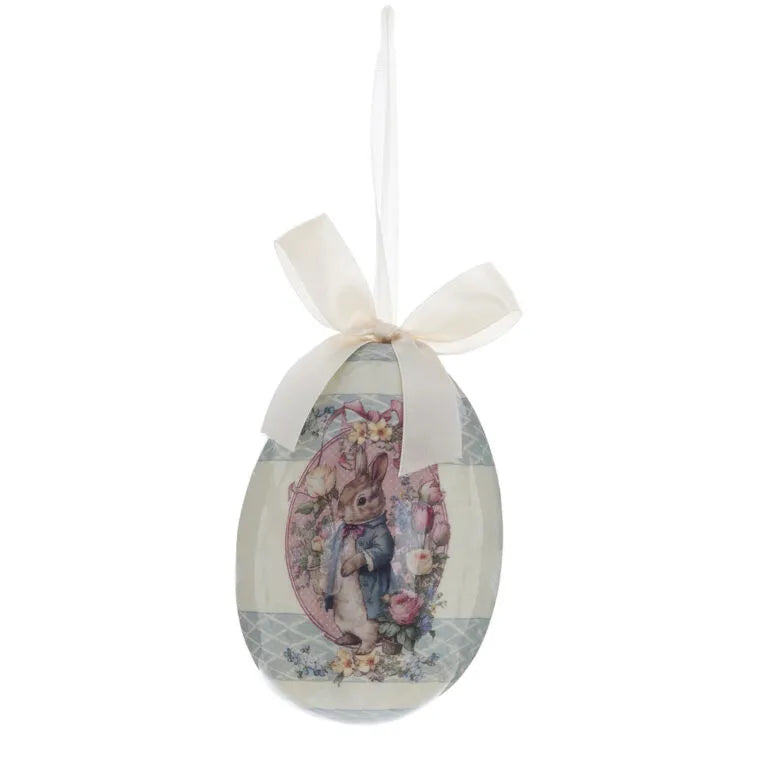 Decorazione pasquale vintage con un coniglio elegante circondato da un medaglione rosa a pois e fiocco avorio.