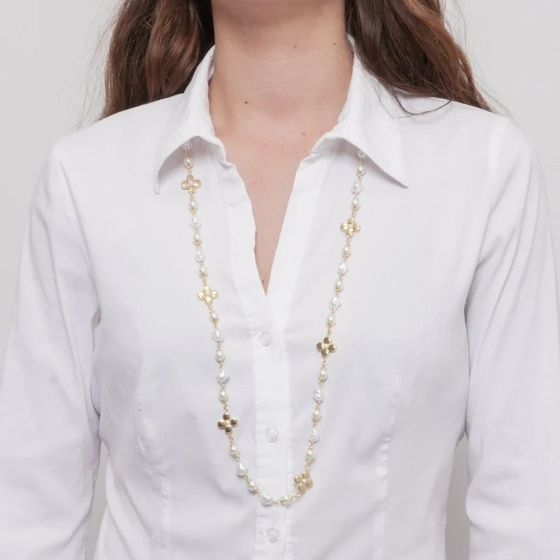 Collana in metallo dorato con perle bianche classiche, perle barocche irregolari e tre fiori a quattro petali con perla centrale. Gioiello elegante e variegato, ideale per occasioni speciali e come idea regalo.