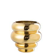 Portacandela e vaso decorativo modello Clea dorato con finitura metallica lucida a effetto specchio, caratterizzato da un design moderno e bombato a cerchi sovrapposti. Questo elegante complemento d'arredo per interni presenta una struttura sagomata a onde, ideale come centrotavola di design o vaso per fiori per arricchire la casa.