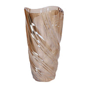 Vaso in vetro artistico di colore ambra trasparente del marchio Vacchetti, caratterizzato da una superficie lavorata con motivi a onda a spirale e bordo superiore irregolare e sinuoso.