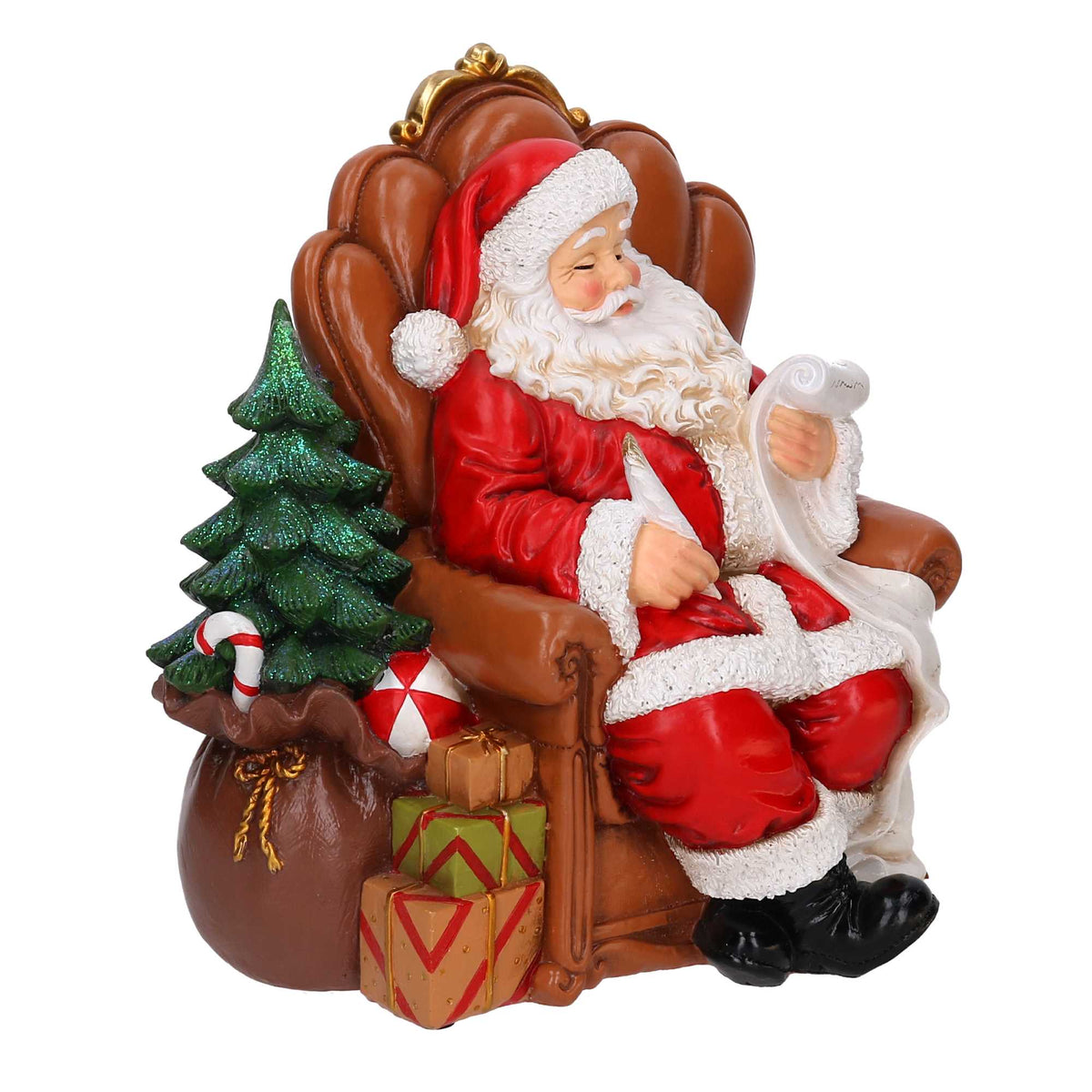 Statuina Vacchetti in resina di Babbo Natale seduto su poltrona mentre scrive la lista dei regali, con albero glitterato e pacchi colorati. Decorazione natalizia dipinta a mano, ideale per l’home décor e come idea regalo.