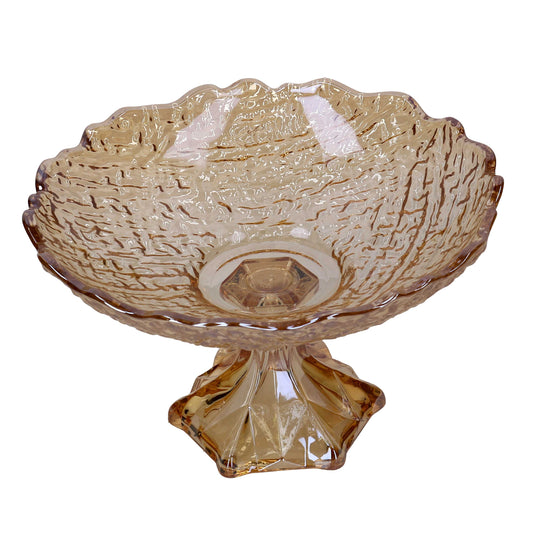 Alzata concava in vetro color ambra con bordi frastagliati ondulati e superficie dalla texture increspata, sorretta da una solida base sfaccettata.