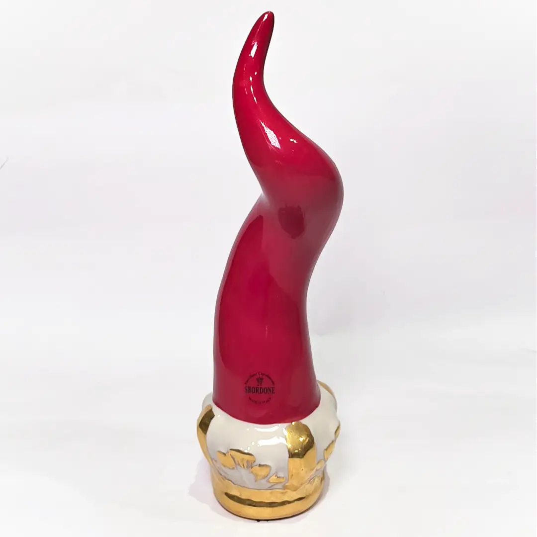 Corno portafortuna Regale in ceramica rossa lucida montato su una raffinata base d'appoggio bianca con eleganti venature e finiture dorate. Questo oggetto scaramantico di design artigianale, sormontato da una corona oro, rappresenta un complemento d'arredo esclusivo ideale per impreziosire interni moderni o classici.