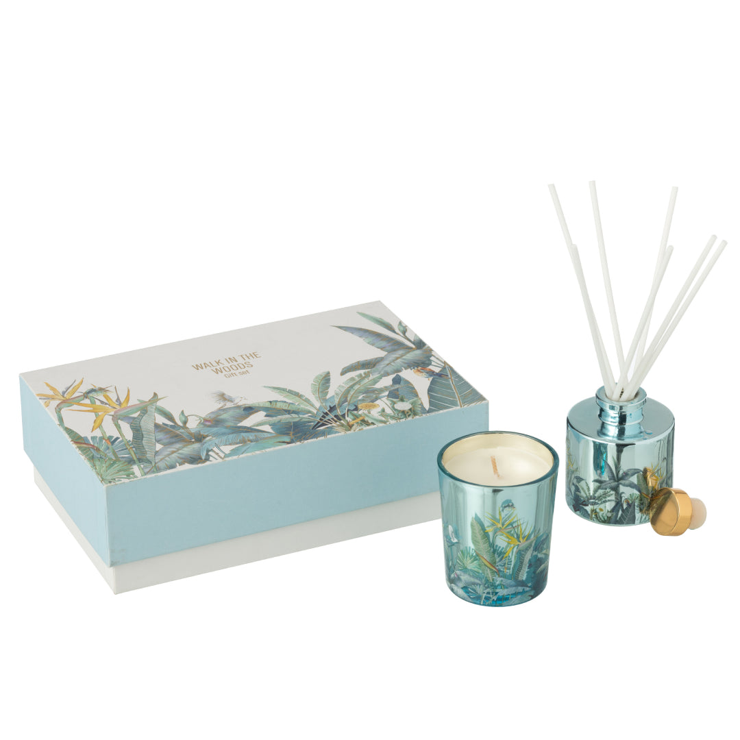 Il Set Regalo Candela e Diffusore Walk in the Woods Jolipa è un raffinato kit fragranza composto da una candela profumata e un diffusore con bastoncini in eleganti contenitori di vetro azzurro. La profumazione legnosa Woody Blush e la confezione decorata con uccellini e piante tropicali rendono questo set un perfetto complemento d'arredo o un'esclusiva idea regalo per la casa.