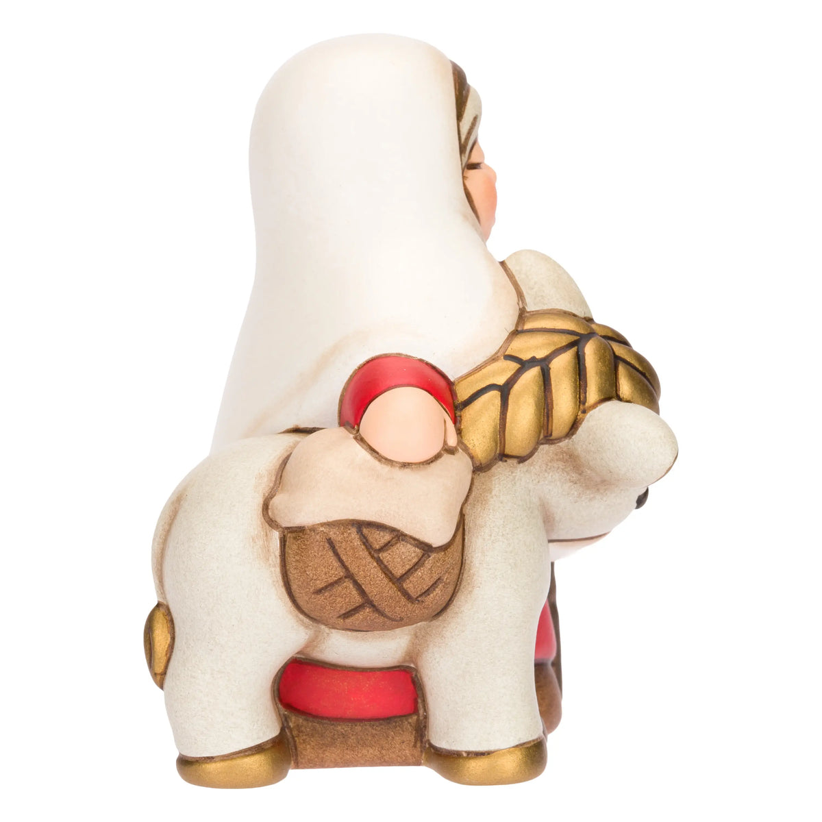 Statuina in ceramica raffigurante una donna del presepe con velo bianco e veste rossa, che accompagna un asinello con basto dorato appoggiando la mano sulla sua testa. Personaggio dal design classico e curato firmato THUN, ideale per arricchire il presepe o come idea regalo natalizia.