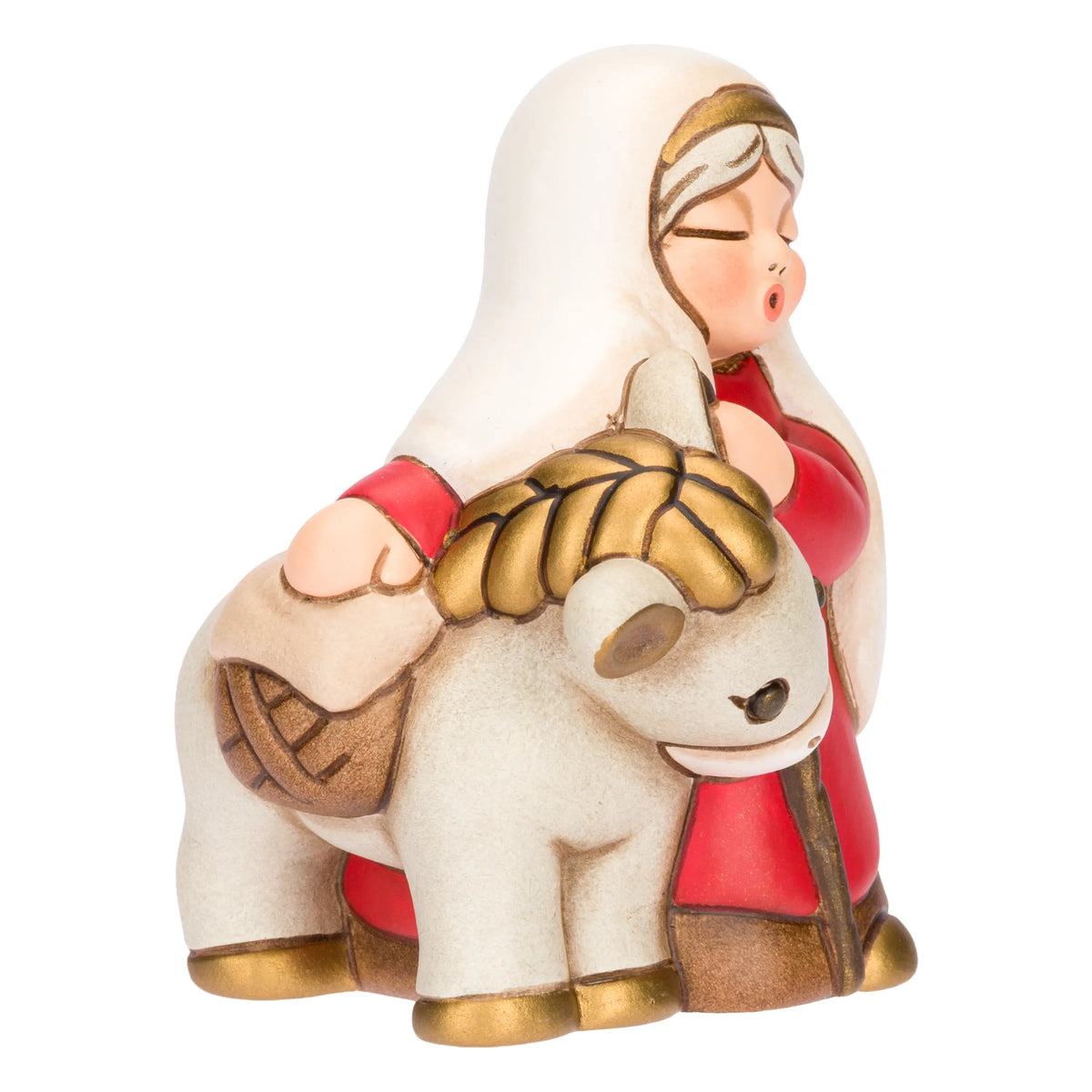 Statuina in ceramica raffigurante una donna del presepe con velo bianco e veste rossa, che accompagna un asinello con basto dorato appoggiando la mano sulla sua testa. Personaggio dal design classico e curato firmato THUN, ideale per arricchire il presepe o come idea regalo natalizia.