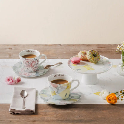 Alzata Thun "Incanto di Pasqua" inserita in un'ambientazione tavola apparecchiata, utilizzata per esporre ovetti di cioccolato e dolci pasquali. Un complemento d'arredo elegante per la sala da pranzo.