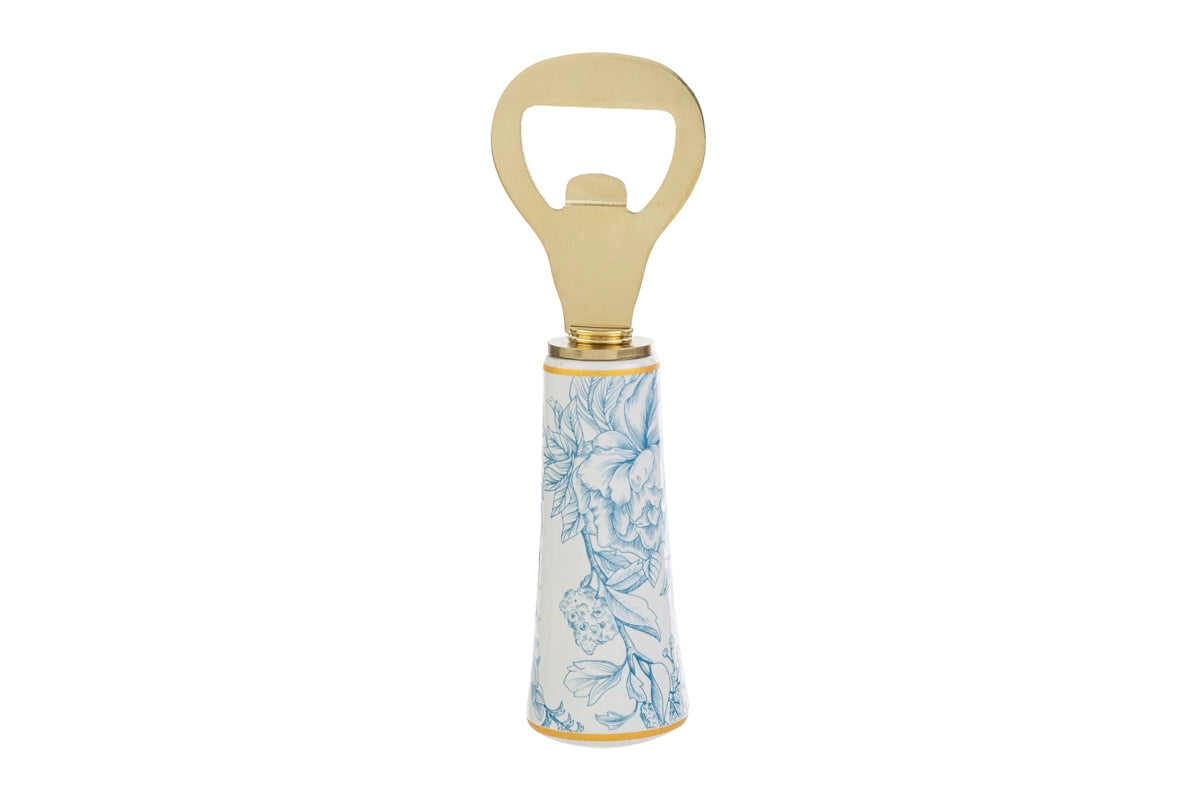 Apribottiglie con decoro azzurro firmato Le Stelle, caratterizzato da una solida testa in metallo color oro e un elegante manico in porcellana bianca decorato con delicati motivi floreali azzurri. Questo raffinato utensile da cucina e bar di design è accompagnato dalla sua custodia regalo rettangolare coordinata con la stessa fantasia botanica, perfetto come bomboniera di classe o idea regalo home decor.