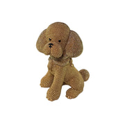 Statuina in resina raffigurante un cagnolino dorato seduto con lunghe orecchie pendenti e una sciarpa arrotolata al collo, interamente ricoperto di brillantini glitterati, con occhi e naso neri. Oggetto decorativo scintillante firmato Sud Import, ideale come soprammobile per bambini o idea regalo per gli amanti degli animali.