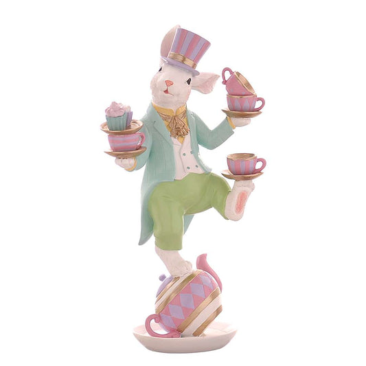 Decorazione pasquale Vetur in poliresina h 41,5 cm. Grande scultura con coniglio bianco in piedi su una teiera rosa, intento a giocolare con tazze da tè e piattini colorati in un equilibrio verticale.