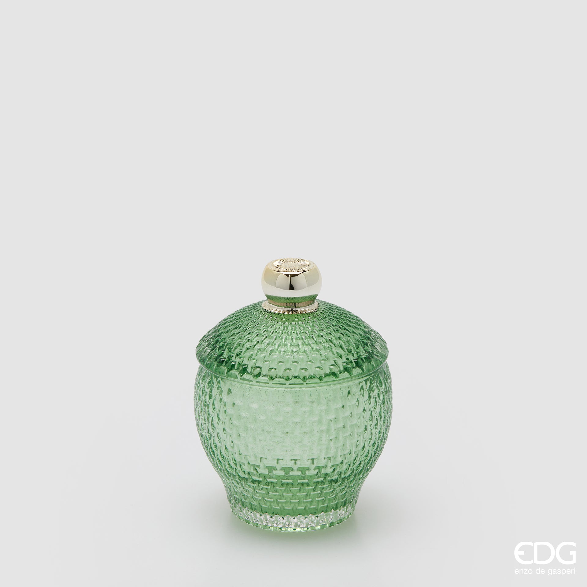 Contenitore decorativo EDG Enzo de Gasperi in vetro verde lavorato con trama a rilievo. Design bombato con coperchio coordinato e pomello dorato, ideale come portaoggetti o elemento d'arredo.
