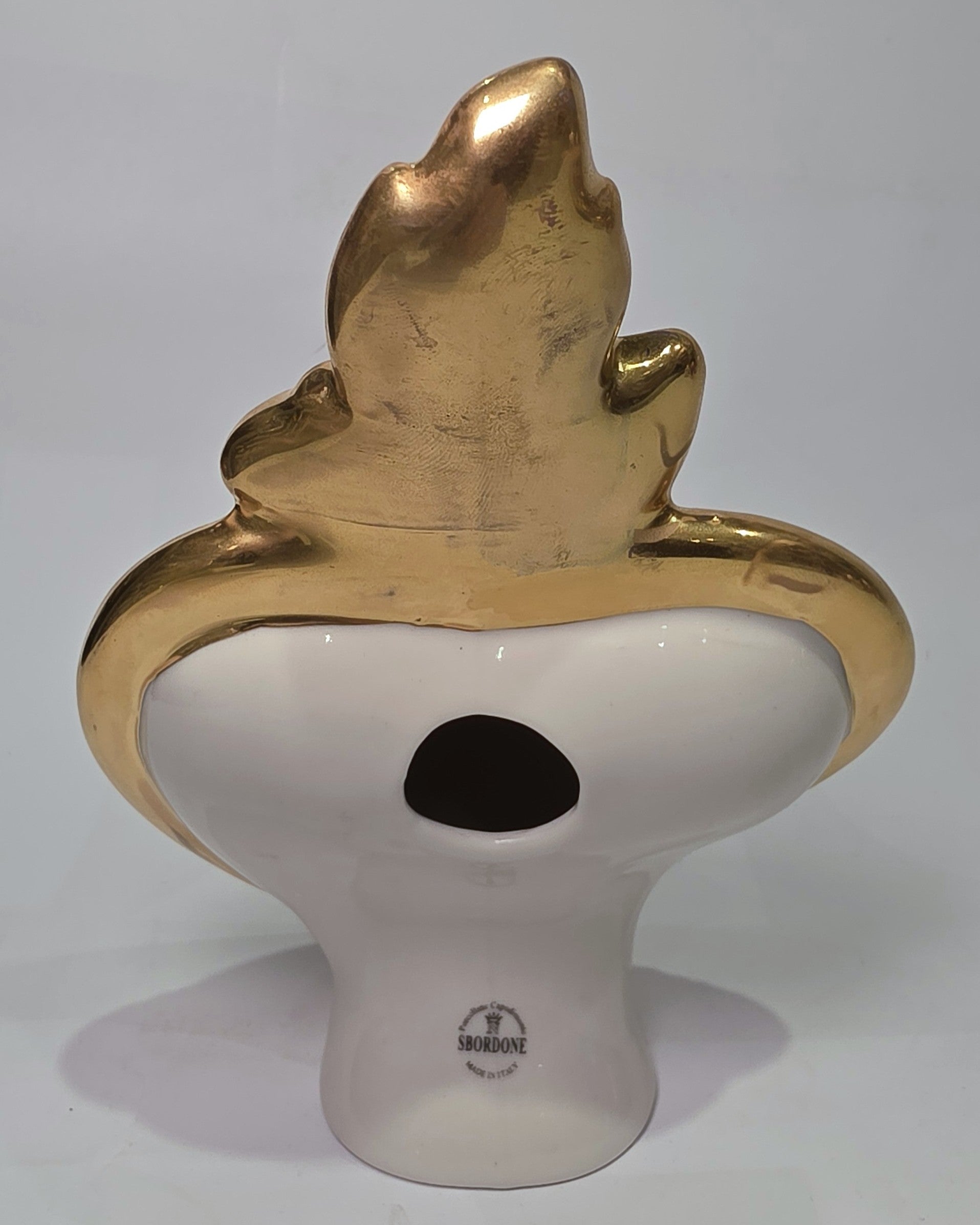 Scultura a forma di Cuore Sacro in ceramica nera lucida, impreziosita da una ricca cornice dorata lavorata a sbalzo e decorata con loghi fashion iconici in oro. Questo esclusivo oggetto d'arredo in stile pop art presenta una fiamma superiore dorata e una base d'appoggio integrata, perfetto per aggiungere un dettaglio di lusso moderno agli ambienti interni.