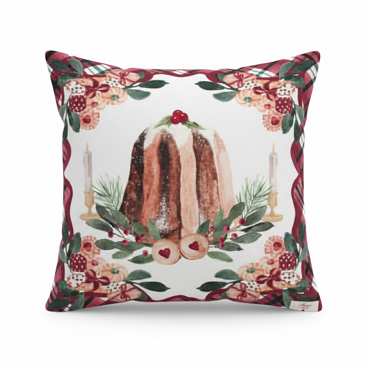 Cuscino natalizio Blanc Mariclo con stampa centrale di un pandoro decorato con bacche rosse, affiancato da candele e rami di pino. Bordatura perimetrale con motivo scozzese rosso e verde su fondo bianco.