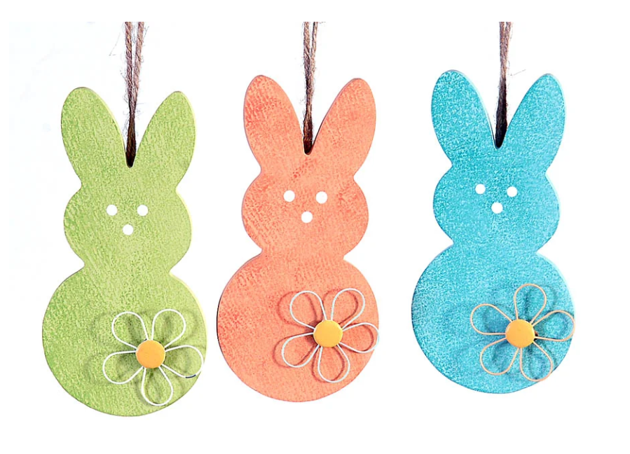 Tris di decorazioni pasquali pendenti in legno a forma di sagoma di coniglio. Il set comprende tre colori assortiti con finitura materica: verde mela, arancione e azzurro. Ogni coniglio è decorato con un fiore stilizzato in rilievo sulla base e presenta tre piccoli fori che disegnano il muso; sono appesi a un cordino di juta naturale.