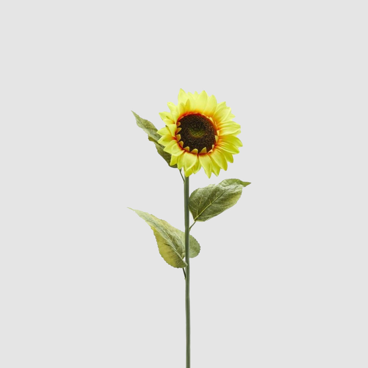 Ramo di girasole maxi EDG con grandi petali gialli e cuore scuro granuloso, su stelo con foglie verdi vellutate. Fiore artificiale decorativo, ideale per l’home décor e come idea regalo.