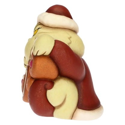 L'immagine mostra il profilo destro della statuina in ceramica del Grinch, evidenziandone la forma compatta e bombata. Da questa angolazione è visibile la curva della schiena e del cappello rosso, che termina con un pompon bianco sulla nuca. Il braccio e la mano verde del personaggio avvolgono il lato della struttura, mentre la base rossa e le parti in "pan di zenzero" mostrano uno spessore uniforme e levigato.