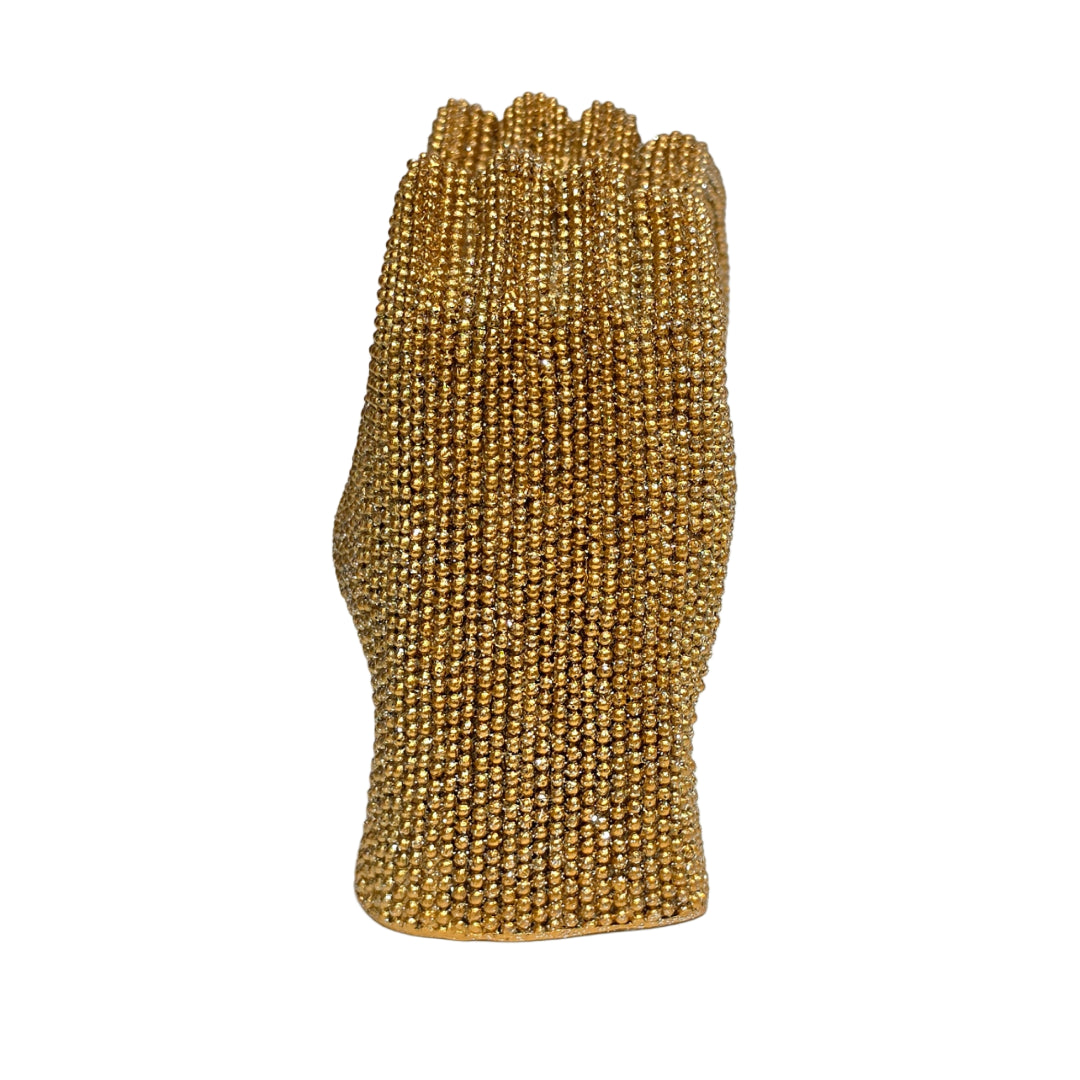 Statuina in resina raffigurante due mani dorate intrecciate a formare un cuore, interamente ricoperte di brillantini glitterati dall'effetto scintillante. Oggetto decorativo firmato Sud Import, ideale come soprammobile romantico o idea regalo per San Valentino e occasioni speciali.