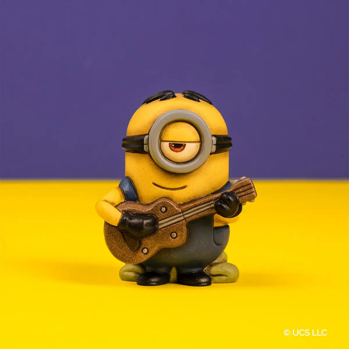 Statuina da collezione Stuart Minions x Thun in edizione limitata. Stuart è raffigurato seduto mentre abbraccia teneramente il suo orsetto di peluche, caratterizzato dai classici decori floreali Thun. Realizzato in ceramica con finitura materica opaca, presenta i colori iconici giallo e blu salopette con il logo "G" di Gru.