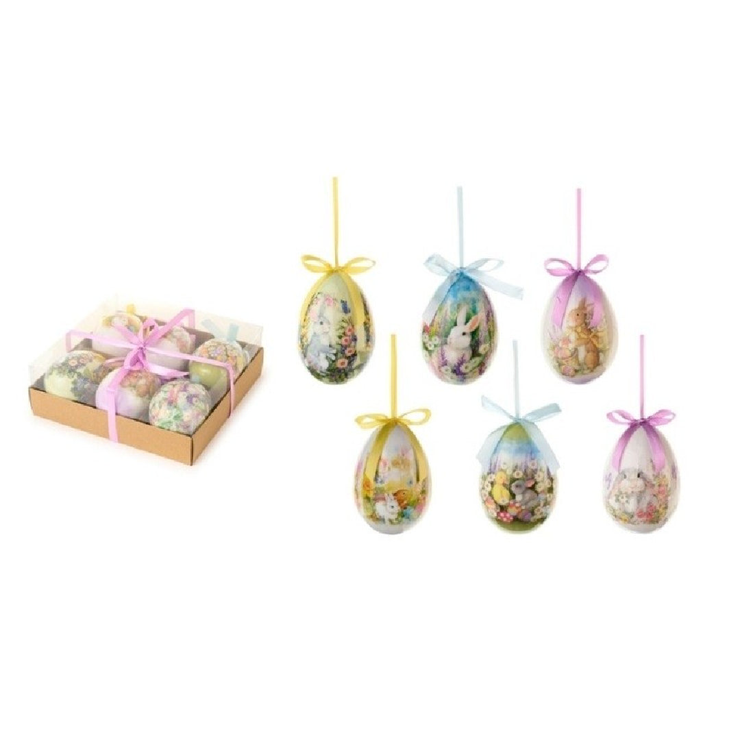 Set da 6 uova decorative della collezione "Dorothy" di Nuvole di Stoffa, ideali come addobbi pasquali da appendere o come abbellimento per l'albero di Pasqua. Ogni uovo presenta illustrazioni a tema primaverile con coniglietti e fiori in tonalità pastello, completato da un nastrino colorato e presentato in una scatola regalo in cartoncino con fiocco rosa.