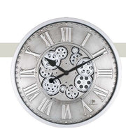 Orologio da parete circolare "Ingranaggi Rotanti Silver" di Justaminute. Il design è caratterizzato da un quadrante in metallo argentato con finitura spazzolata, numeri romani classici a rilievo lungo il bordo e un centro a vista che rivela un complesso meccanismo di ingranaggi neri e grigi. Le lancette nere a goccia contrastano con il fondo metallico, mentre il logo "jm Justaminute" è posizionato in basso a destra.