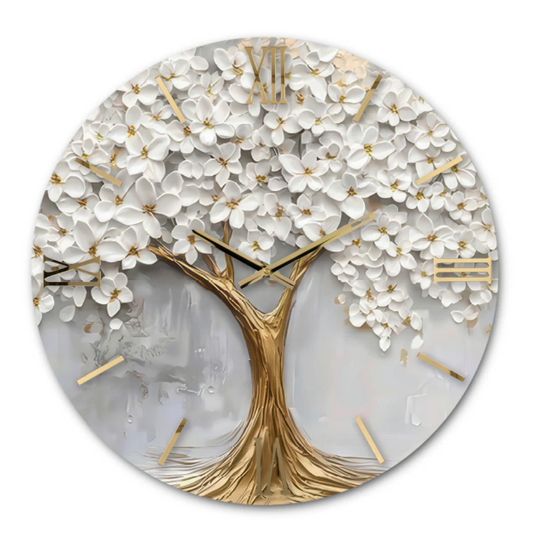 Orologio da parete circolare "Quercia" di Artidea. Il quadrante presenta un design artistico in rilievo raffigurante un albero stilizzato (quercia) con il tronco e i rami in tonalità oro metallizzato. La chioma è composta da numerosi fiori bianchi tridimensionali che creano un effetto materico e rigoglioso. Gli indici in numeri romani e le lancette sottili sono realizzati in metallo dorato lucido.