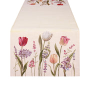 Runner primaverile Nuvole di Stoffa con bordo decorato da tulipani colorati, piante e fiori. Tessuto elegante per la tavola di Pasqua 2026