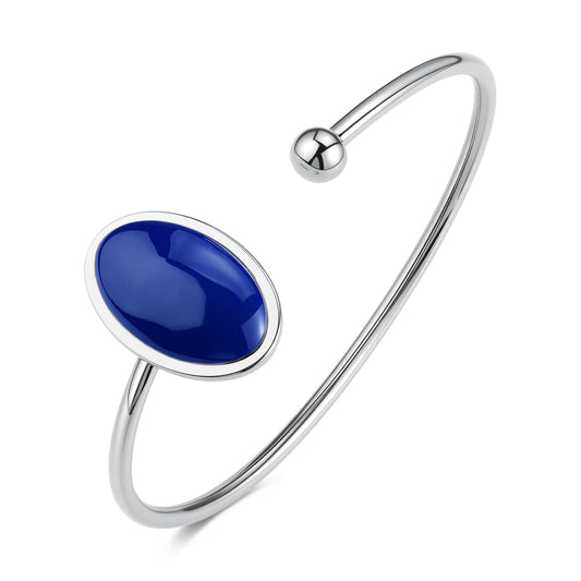 Bracciale rigido aperto S'Agapõ della collezione Madame in acciaio lucido, caratterizzato da due sfere terminali di cui una ovale con pietra blu zaffiro.