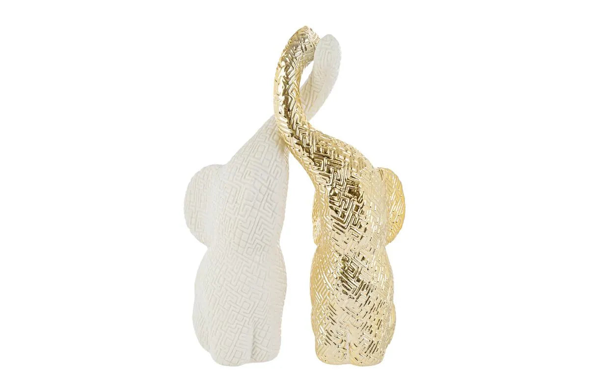 Set di due elefantini decorativi in porcellana bianco e oro firmati Le Stelle, caratterizzati da una finitura lucida impreziosita da una trama geometrica a rilievo con effetto 3D e trombe sollevate che si incrociano. Queste due raffinate statuine di elefanti di design rappresentano un complemento d'arredo moderno e portafortuna, ideale come bomboniera di classe o originale oggetto ornamentale per la casa.