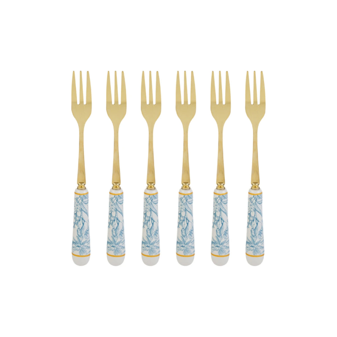 Set di 6 forchettine da dolce con decoro azzurro firmato Le Stelle, caratterizzato da rebbi in metallo color oro e raffinati manici in porcellana bianca decorati con delicati motivi floreali azzurri. Questo elegante servizio di posate da dessert di design è accompagnato dalla sua scatola regalo quadrata coordinata con la stessa fantasia botanica, perfetto come bomboniera di classe o idea regalo home decor.