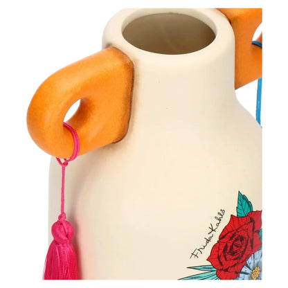 Questo raffinato vaso in ceramica della collezione THUN x Frida Kahlo presenta un design unico ispirato all'iconica artista, con decorazioni floreali vivaci e un cuore sacro centrale. La struttura color crema è arricchita da dettagli modellati a mano che includono farfalle colorate e una corona di fiori tipica dello stile Frida Kahlo. Perfetto come complemento d'arredo artistico, questo vaso THUN medio unisce l'estetica messicana alla dolcezza inconfondibile della ceramica decorata.