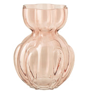 Vaso in vetro trasparente color rosa salmone modello Hubert grande firmato Jolipa, caratterizzato da un design sinuoso con una superficie a coste verticali e un collo stretto che si apre in un'ampia imboccatura ondulata. Questo raffinato vaso decorativo si adatta perfettamente a interni moderni ed eleganti, ideale sia come portafiori sia come ricercato complemento d'arredo per la casa.