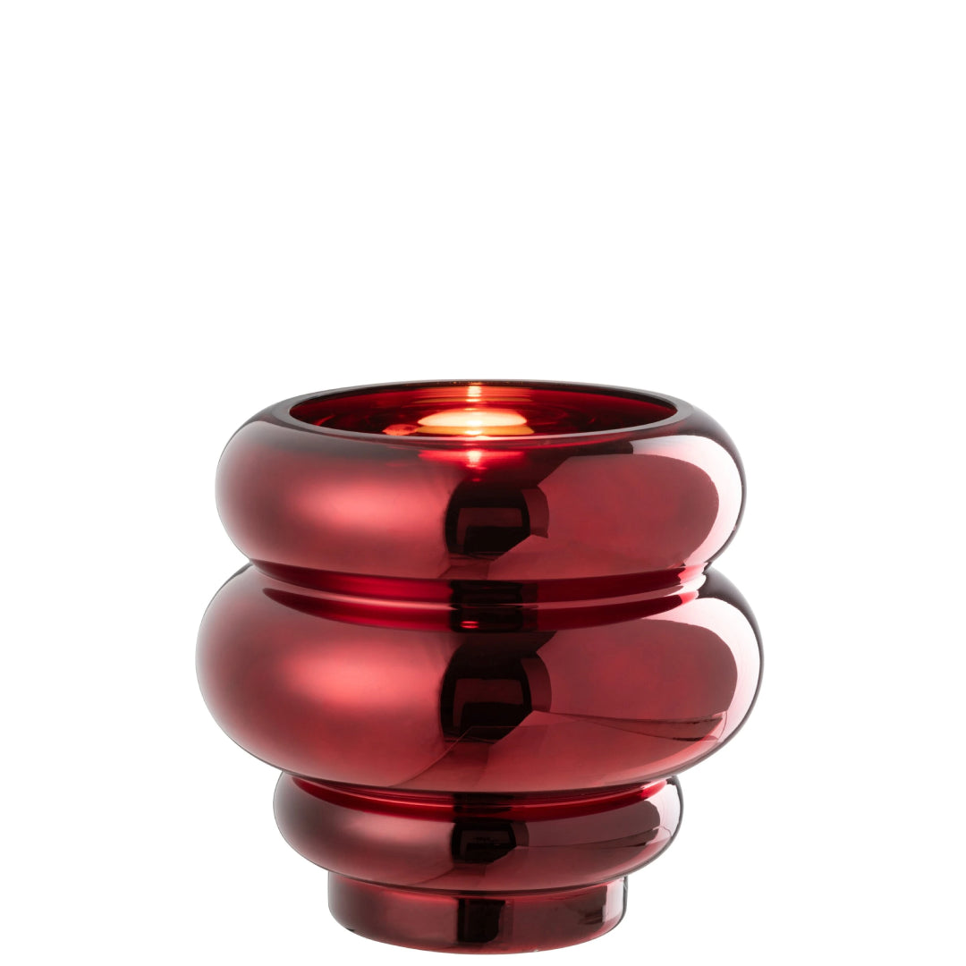 Portacandela e vaso decorativo in vetro lucido color rosso scuro modello Clea firmato Jolipa, caratterizzato da un design moderno e basso con tre sezioni sferiche sovrapposte a diametro decrescente verso la base. Questo versatile complemento d'arredo con finitura metallizzata a specchio è ideale sia come portacandele d'atmosfera sia come piccolo vaso o centrotavola di design per ambienti eleganti e contemporanei.