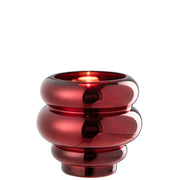 Portacandela e vaso decorativo in vetro lucido color rosso scuro modello Clea firmato Jolipa, caratterizzato da un design moderno e basso con tre sezioni sferiche sovrapposte a diametro decrescente verso la base. Questo versatile complemento d'arredo con finitura metallizzata a specchio è ideale sia come portacandele d'atmosfera sia come piccolo vaso o centrotavola di design per ambienti eleganti e contemporanei.
